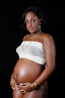 Fertile Prints: pretty pregnant black girl on a black backgroud