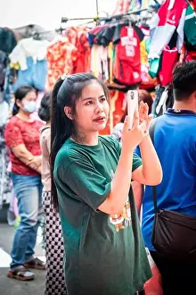 Market Stall Prints: A pretty Thai market stall holder records the clothes on her stall in Pratu Nam Market