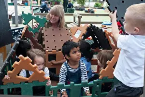 Pupils Prints: Primary school aged children playing outside on activity bars