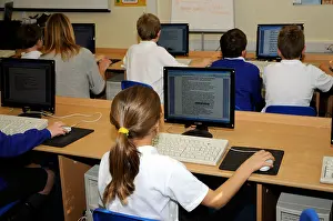 Teachers Prints: Primary school pupils using computers in classroom