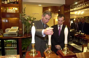Pulling Prints: Prince Charles pulls a pint at the Poet Laureate Pub in Poundbury Dorset