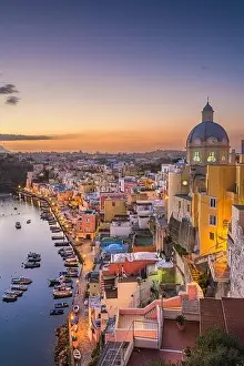 Procida, Italy old town skyline in the Mediterranean Sea during dusk