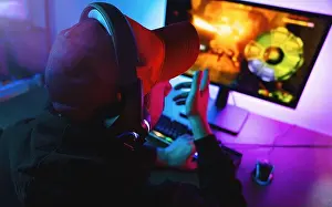 Gamer Prints: Professional Gamer pointing and Playing in First-Person Shooter Online Video Game on His Personal Computer