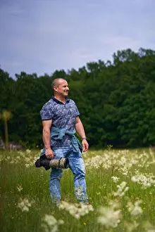 Dslr Prints: Professional nature photographer in the field by the forest