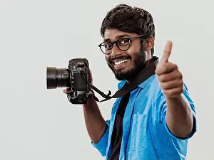 Dslr Prints: Professional photographer having DSLR camera taking picture