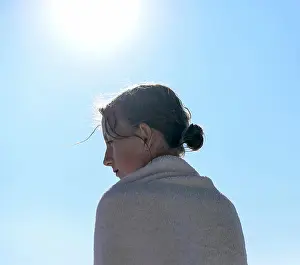 Sideview Prints: Profile of girl at backlight wrapped in a towel