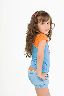 Latino Prints: Side profile of a girl standing with her hand on her hip and smiling