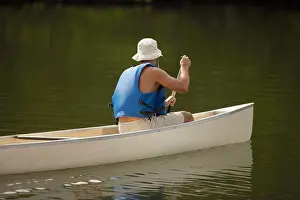 Leisurely Prints: Side profile of a person boating in a river