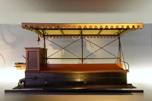 Side View Prints: A profile view of a rare classic late 19th-century motorized tramway carriage inside a museum