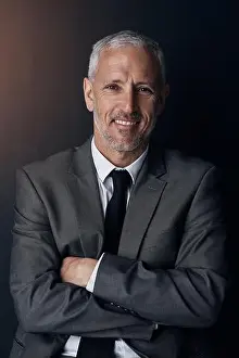 Business Man Prints: Profit is my passion. Studio portrait of a mature businessman against a dark background