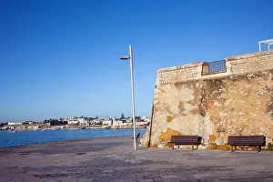 Paved Prints: Promenade witch benches along the Atlantic Ocean coast on a sunny day in Cascais, Portugal