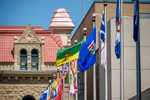 Saskatchewan Prints: Several Provincial flags waving in the wind inn Calgary, Alberta