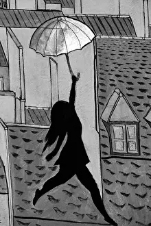 Visual Arts Prints: Public Art work on the streets of Paris France girl dancing on the rooftops with a Umbrella Black and White
