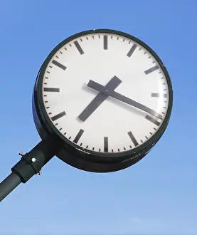 Clock Face Prints: One public clock at a Swedish railroad station isolated on blue sky