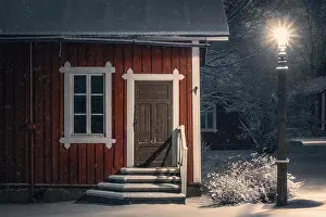Public cozy old cafe place with snow mood at winter evening in Finland. Light snowflakes. This place is open only in summer time