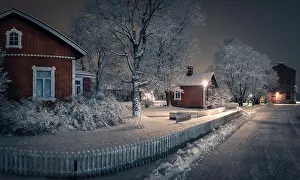 Public park with cozy cafe place and snow covered trees at winter evening in Finland. Cafe place is open only in summertime