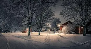 Public park with cozy cafe place and snow covered trees at winter evening in Finland. Cafe place is open only in summertime