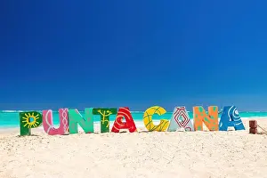 Dominican Prints: Punta Cana lettering on the beach Punta Cana. Written text on the sea beach
