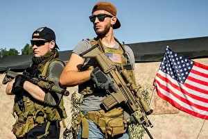Military Uniform Prints: Purposeful young men in sunglasses standing with modern rifles at shooting range