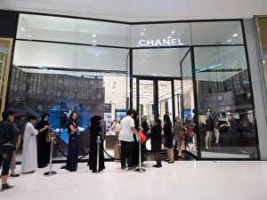 Chanel Prints: Queue of shoppers outside Chanel boutique at The Dubai Mall in Dubai United Arab Emirates
