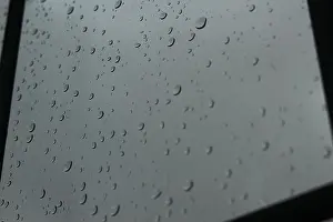 Despair Prints: Rain drops on clear glass window on an overcast foggy day