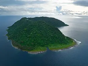 Rainforest covers the remote Mary Island which is fringed by a coral reef in the Solomon Islands. This country is home to amazing marine biodiversity