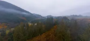 Boring Prints: Rainy foggy and gray weather in the mountain valley of the Carpathians in Ukraine in small village Aerial panoramic