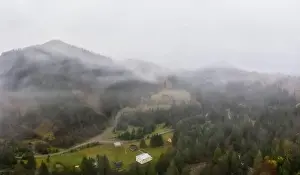 Boring Prints: Rainy foggy and gray weather in the mountain valley of the Carpathians in Ukraine in small village Aerial panoramic