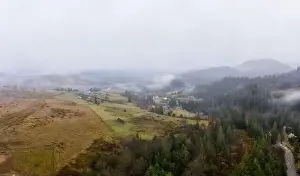 Boring Prints: Rainy foggy and gray weather in the mountain valley of the Carpathians in Ukraine in small village Aerial panoramic