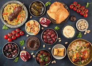 Directly Above Prints: Ramadan kareem Iftar party table with assorted festive traditional Arab dishes