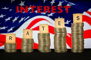 Rising Prints: Interest Rates Rising text Coin Stacks American Flag