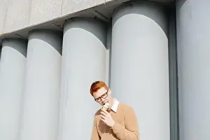 Redhead Prints: Ravenous young ginger man in glasses eating ice cream cone