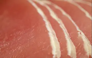 Lean Prints: Raw marinated pork lean loin cut into thin sliced with almost all of the fat trimmed