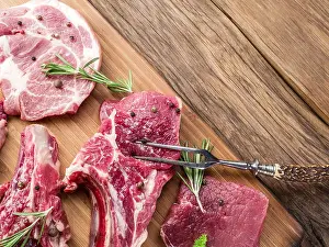 Cutting Board Prints: Raw meat steaks with spices on the wooden cutting board
