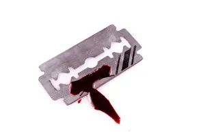 Razor Prints: razor with drop of blood on white background