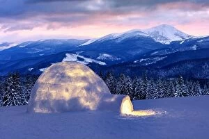 Images Dated 2nd February 2015: Real snow igloo house in the winter mountains. Snow-covered firs