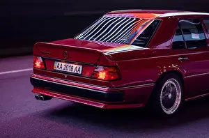 Tail Light Prints: Rear three quarter view of Mercedes-Benz 400E (W124) in AMG body kit at night