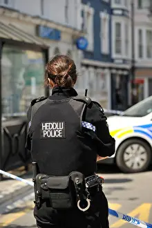 Constable Prints: Rear view of a Dyfed Powys Police force woman constable, Wales UK