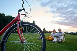 Biking Prints: Red bike and happy couple on the grass