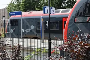Flirt Prints: Red and black trains of R-Net at train station Boskoop between alphen and gouda