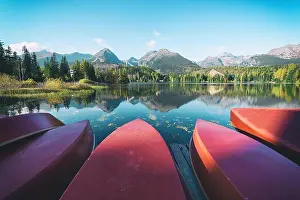 Red boats on Strbske Pleso lake. Location: High Tatras National Park, Slovakia. landscape photography