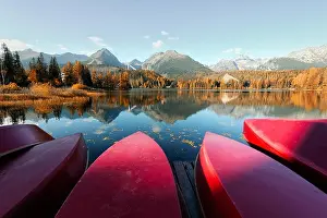 Red boats on Strbske Pleso lake. Location: High Tatras National Park, Slovakia