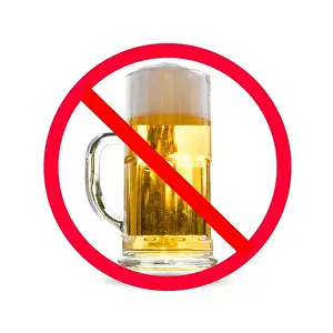 Forbidden Prints: The red circle with slash on glass of beer isolated on white background ; Concept for do not drink alcohol