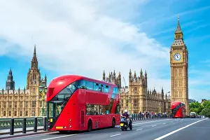 Big Ben Prints: Red double-decker buses pass by Big Ben and the Houses of Parliament on Westminster Bridge