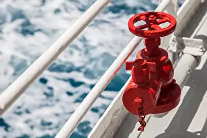 Coupling Prints: Red fire extinguisher with pipe connector on a boat with waves