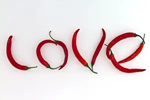 Chilli Prints: Red hot chili peppers arranged as the word LOVE on white background