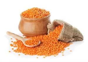 Split Prints: Red lentils in bowl and bag, spoon isolated on a white background closeup