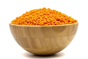 Lentil Prints: Red lentils isolated on white background. Raw red lentils in wooden bowl