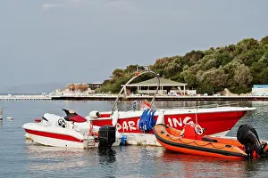 Blue Boat Prints: Red parasailing boat on a calm blue sea of Bodrum, Turkey