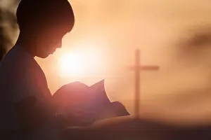 Suffering Prints: Red sunset sky, bright sun light and the holy cross of Jesus Christ